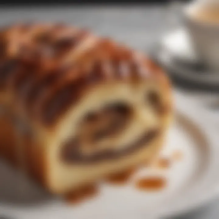 An elegantly plated slice of babka with a cup of coffee