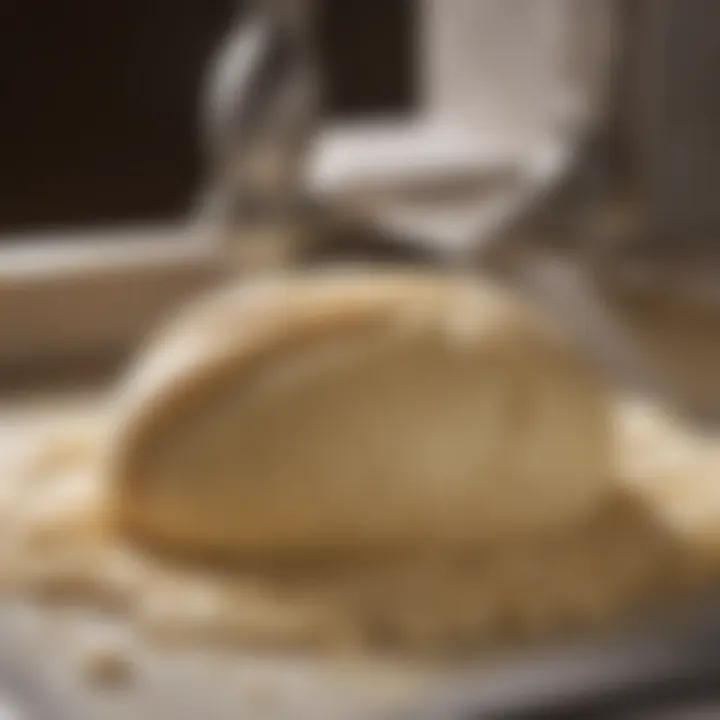 Close-up view of the dough in a kneading machine bowl.