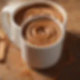 A warm cup of Folgers Cinnamon Swirl Coffee with a sprinkle of cinnamon on top.