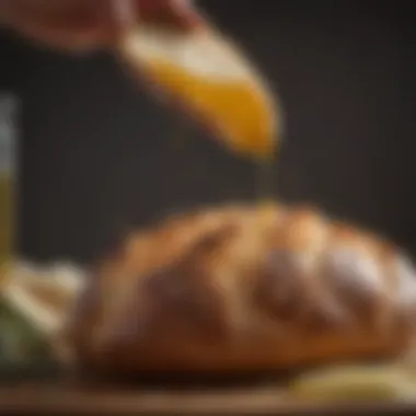 A close-up view of artisan bread being dipped into olive oil