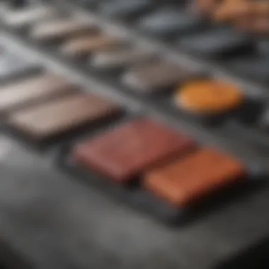 A close-up of diverse flat cooking surfaces made of different materials like cast iron, stainless steel, and stone.