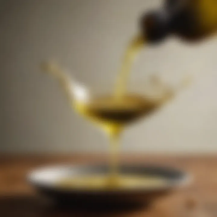 Close-up of olive oil pouring from a bottle, highlighting its rich, golden hue.