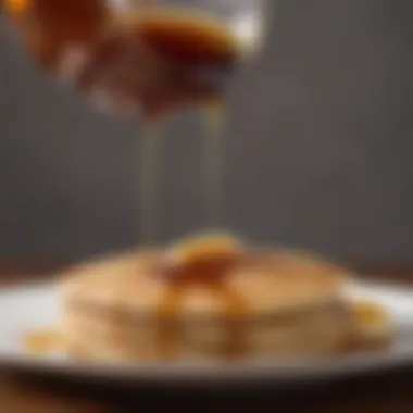 A Culinary Delight: Maple Syrup on Pancakes Close-up of maple syrup being poured on pancakes