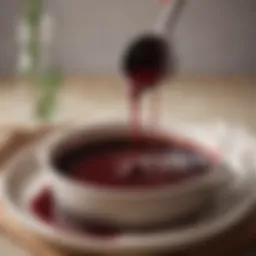 A rich and glossy red wine reduction sauce glistening in a saucepan