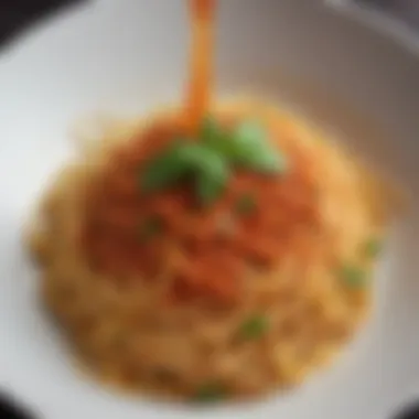 A close-up of spaghetti elegantly plated with sauce and herbs