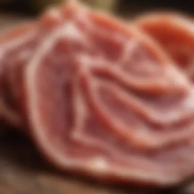 A close-up of thinly sliced prosciutto revealing its marbled texture.