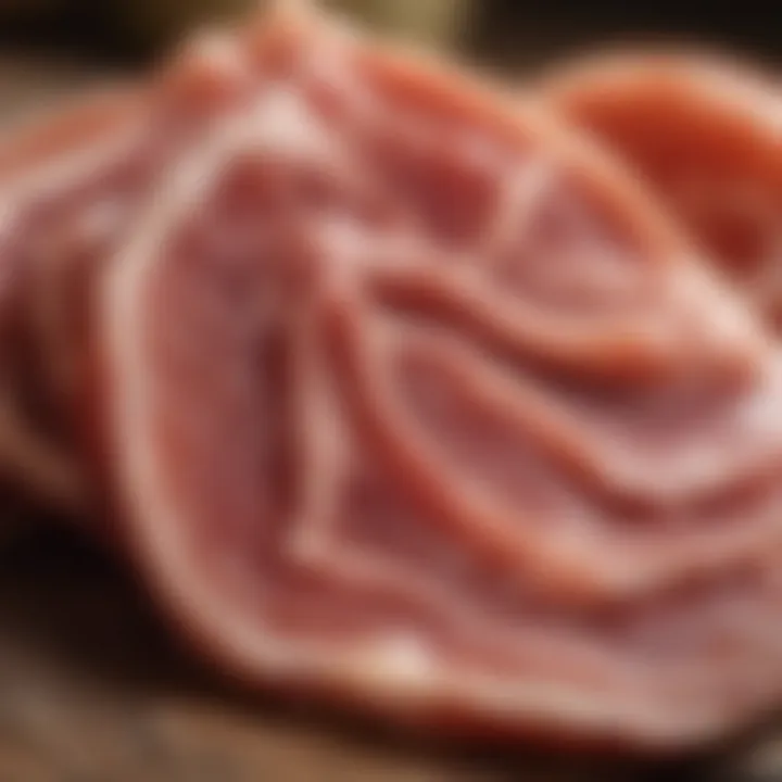 A close-up of thinly sliced prosciutto revealing its marbled texture.